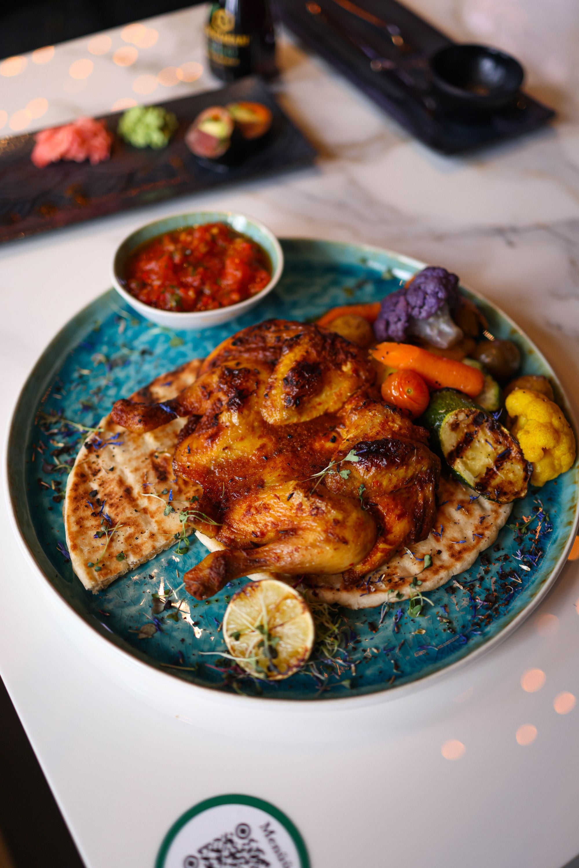 Grilled chicken with vegetables on a blue plate