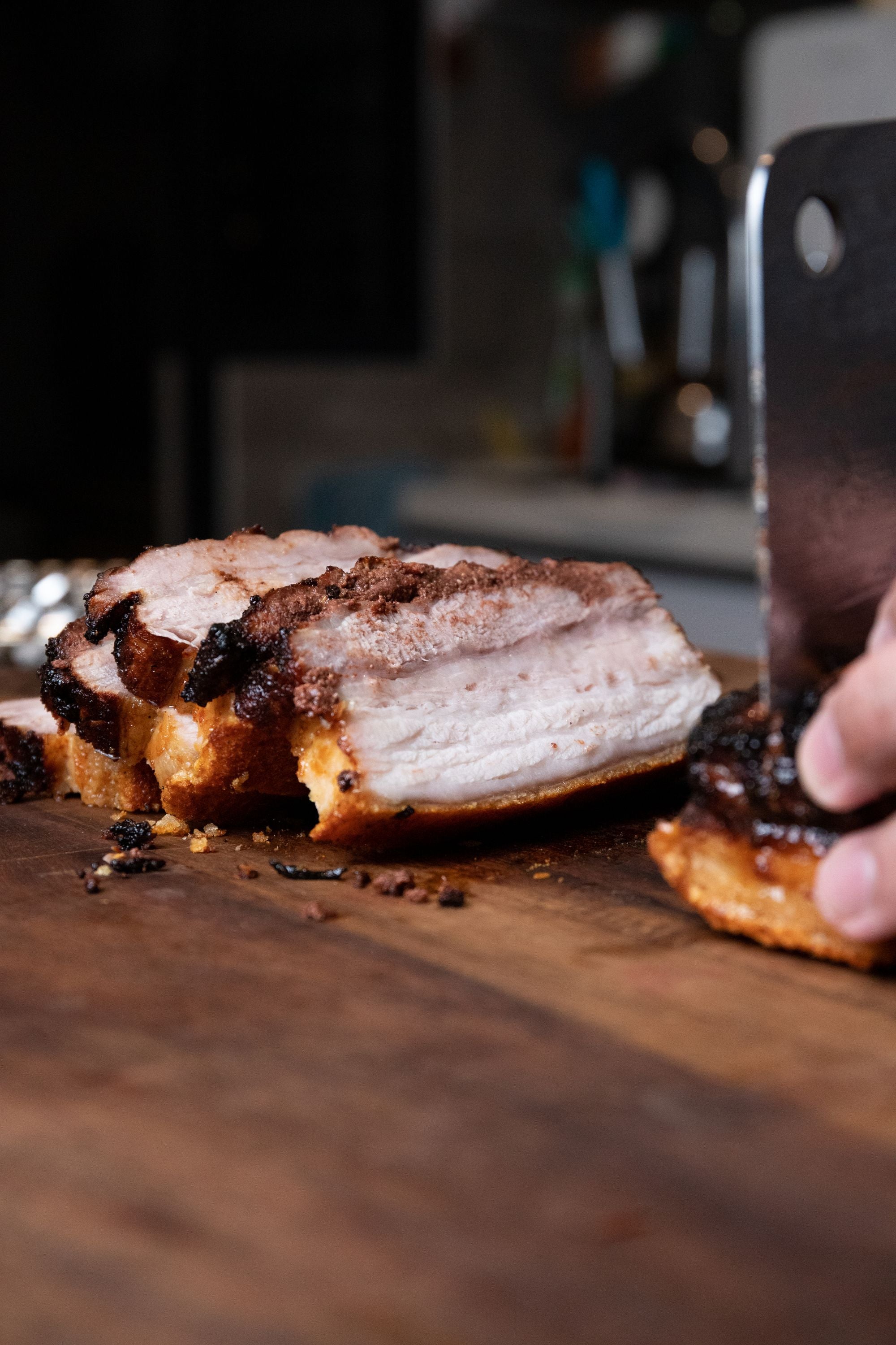 Sliced roasted pork on a wooden board