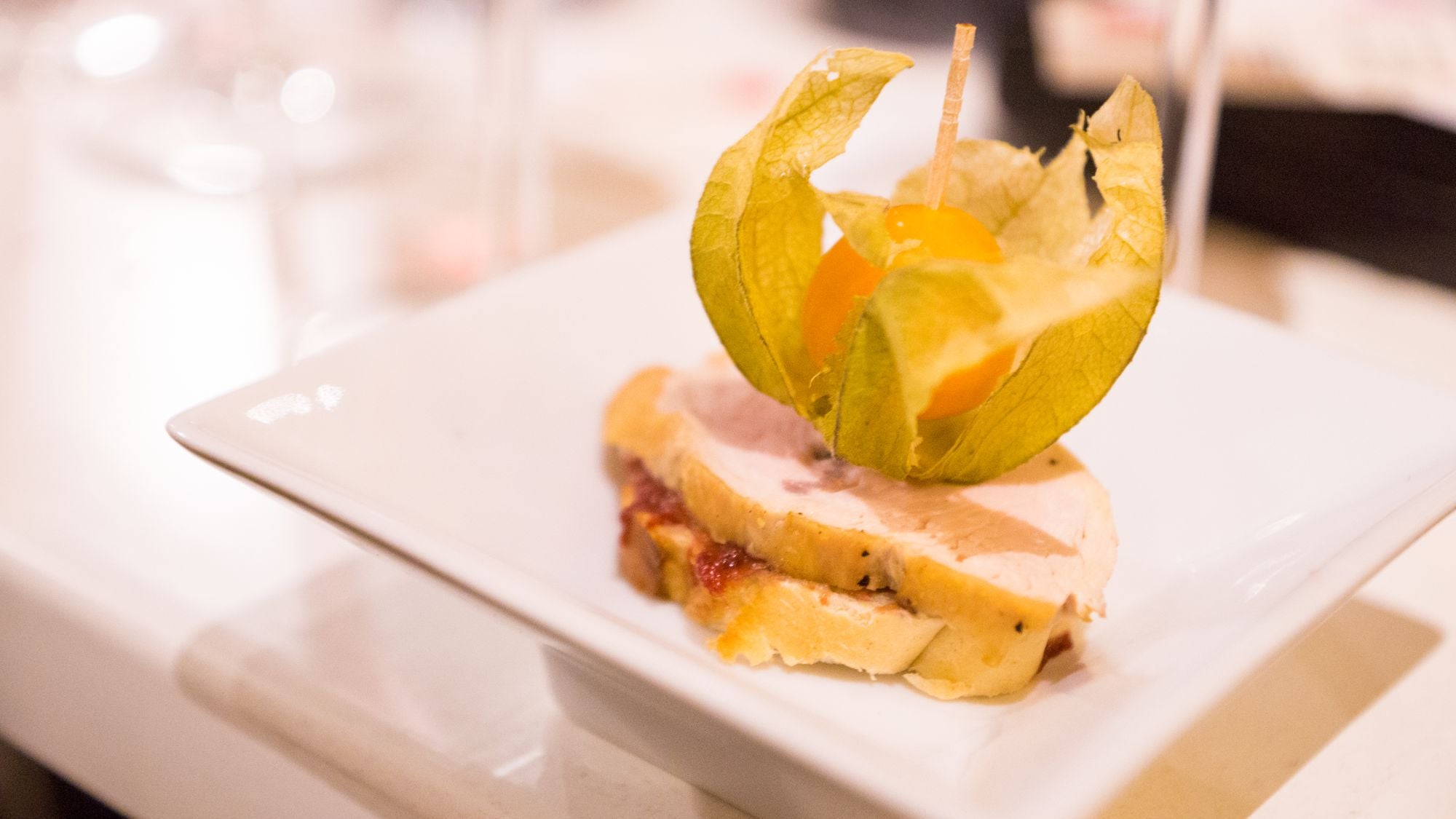 A plated slice of roasted turkey with garnish